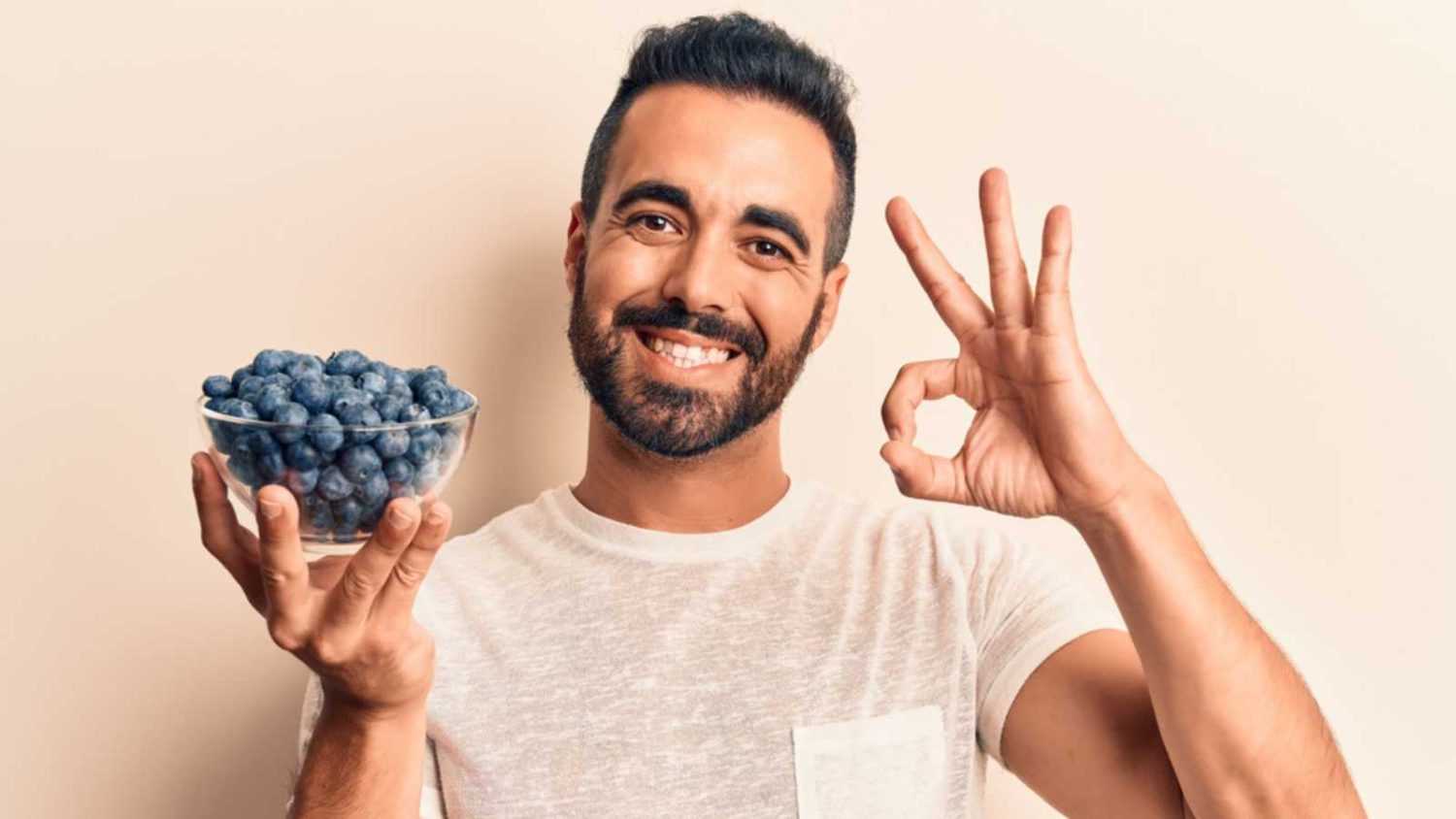 Man holding blueberries