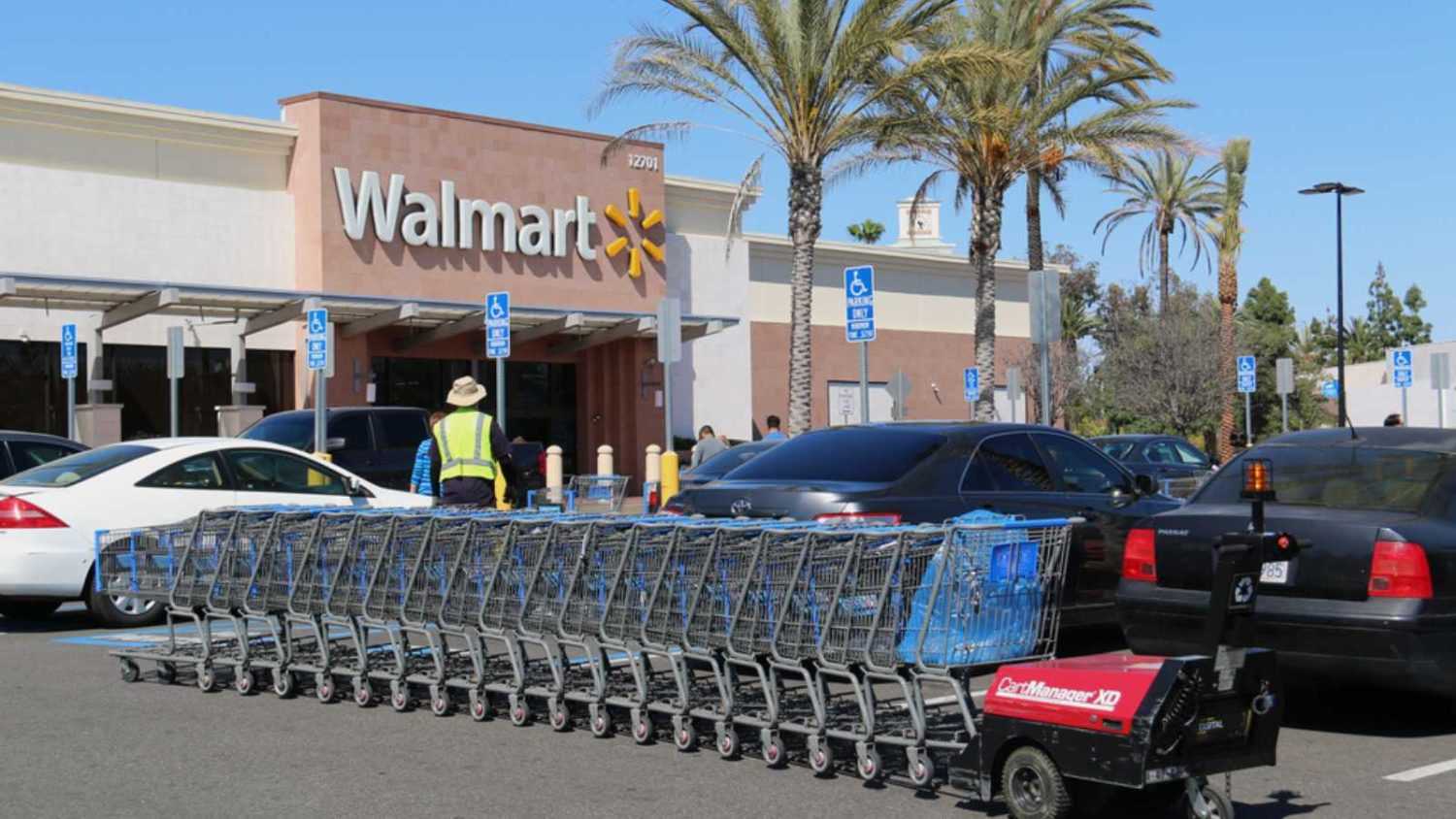 Cerritos, California, USA - April 18, 2016: Carts in parking lot are being pushed by CartManager XD, a shopping cart pusher, to make cart retrieval more efficient and safe.
