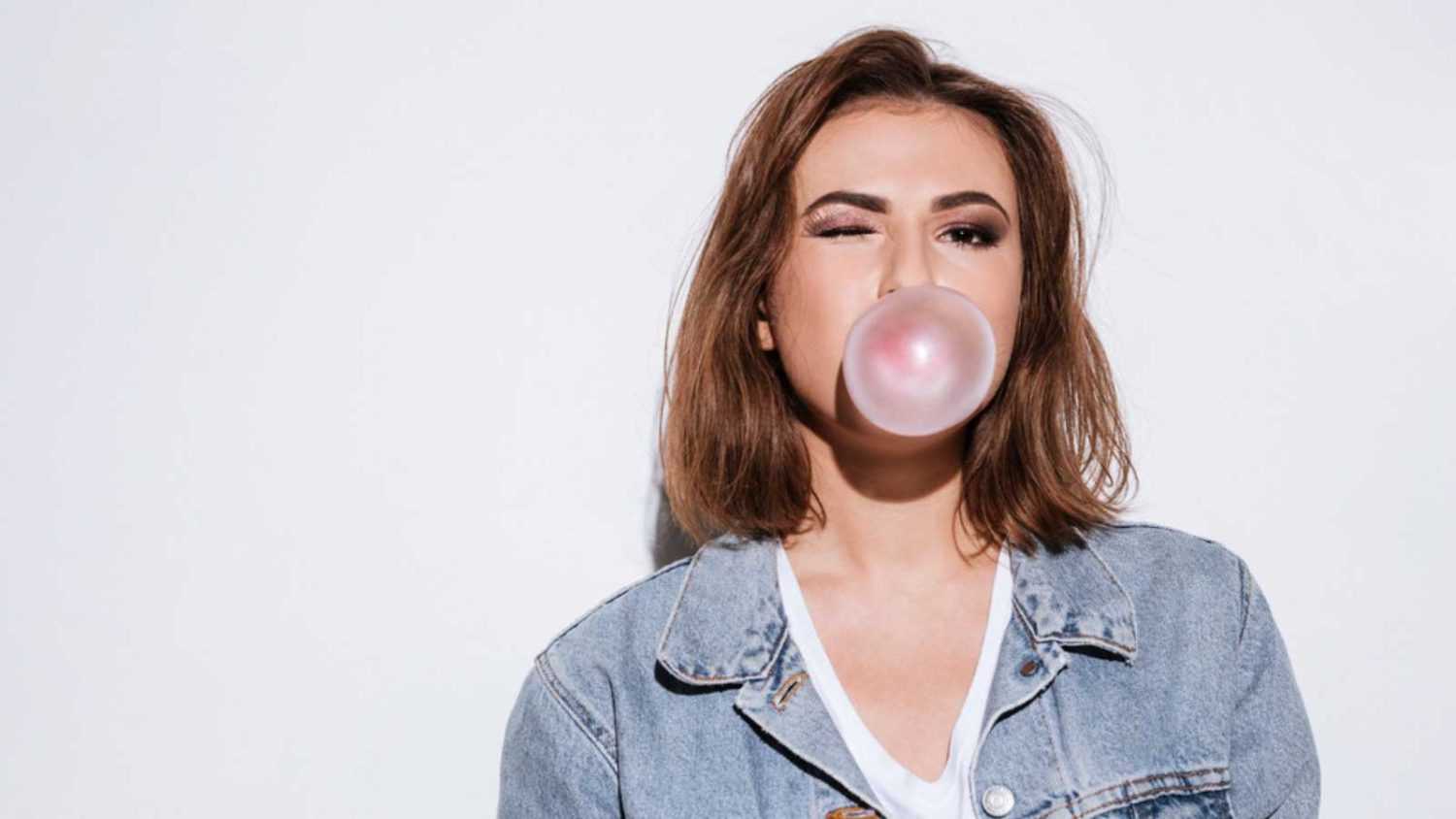 Woman making bubbles with chewing gum