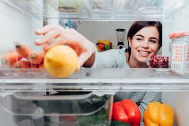 Woman taking items from fridge