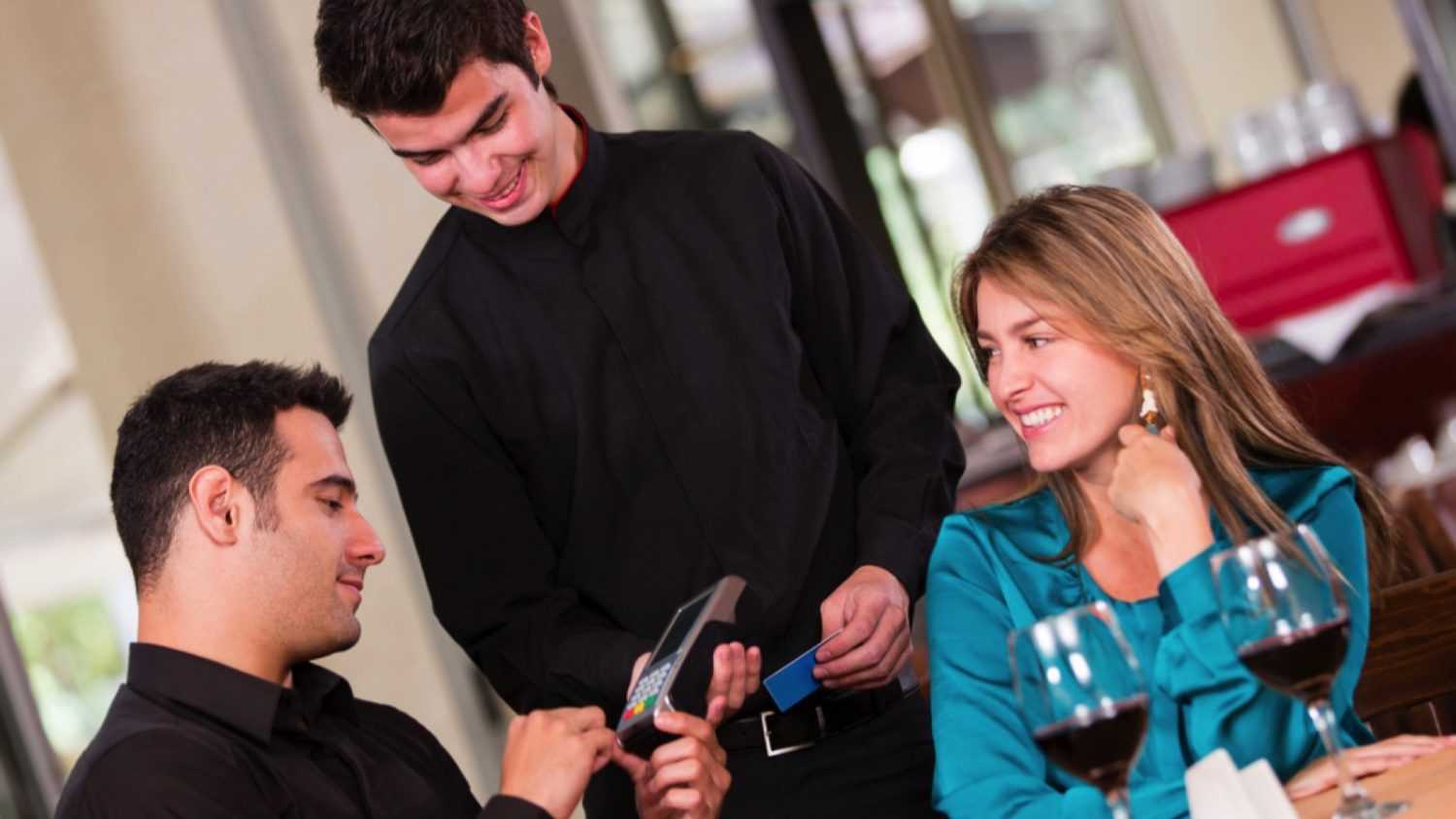 Man at restaurant paying bills