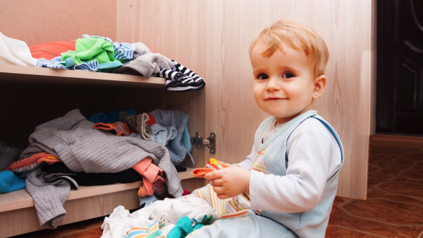 Baby playing in shelf