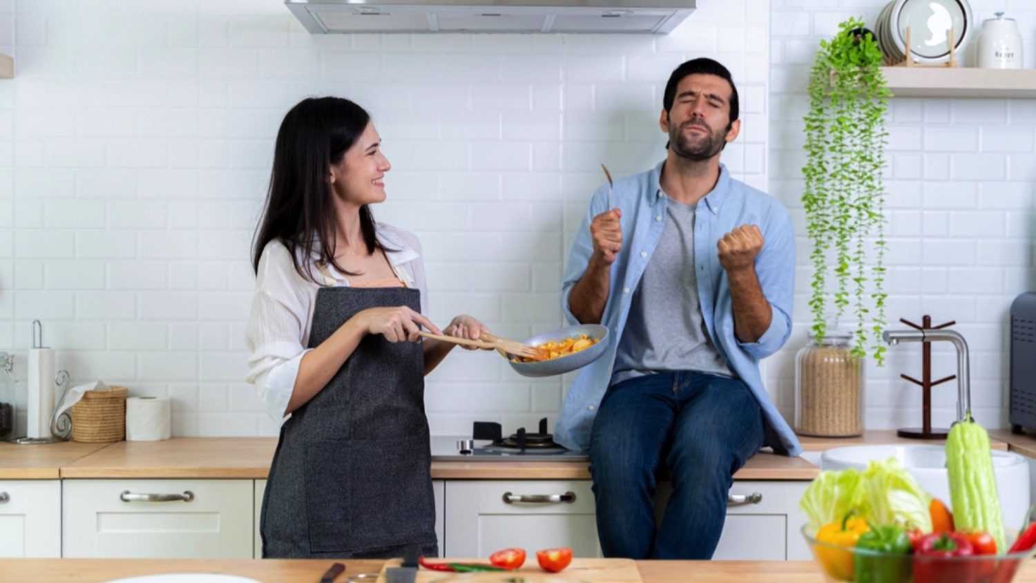 Man tasting wife cooking in good taste