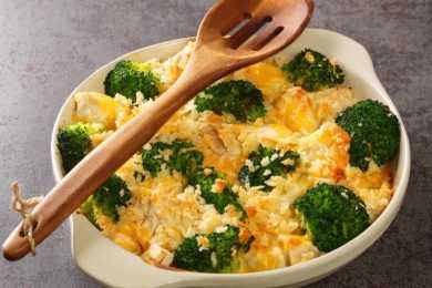 Broccoli Chicken divan is a creamy casserole topped with crispy buttered breadcrumbs close up in the dish on the old table. Horizontal