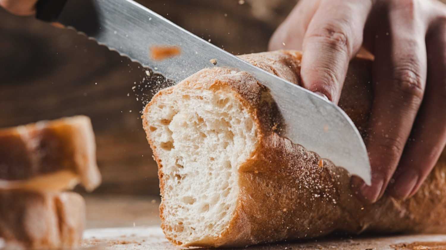 Woman cutting bread loaf