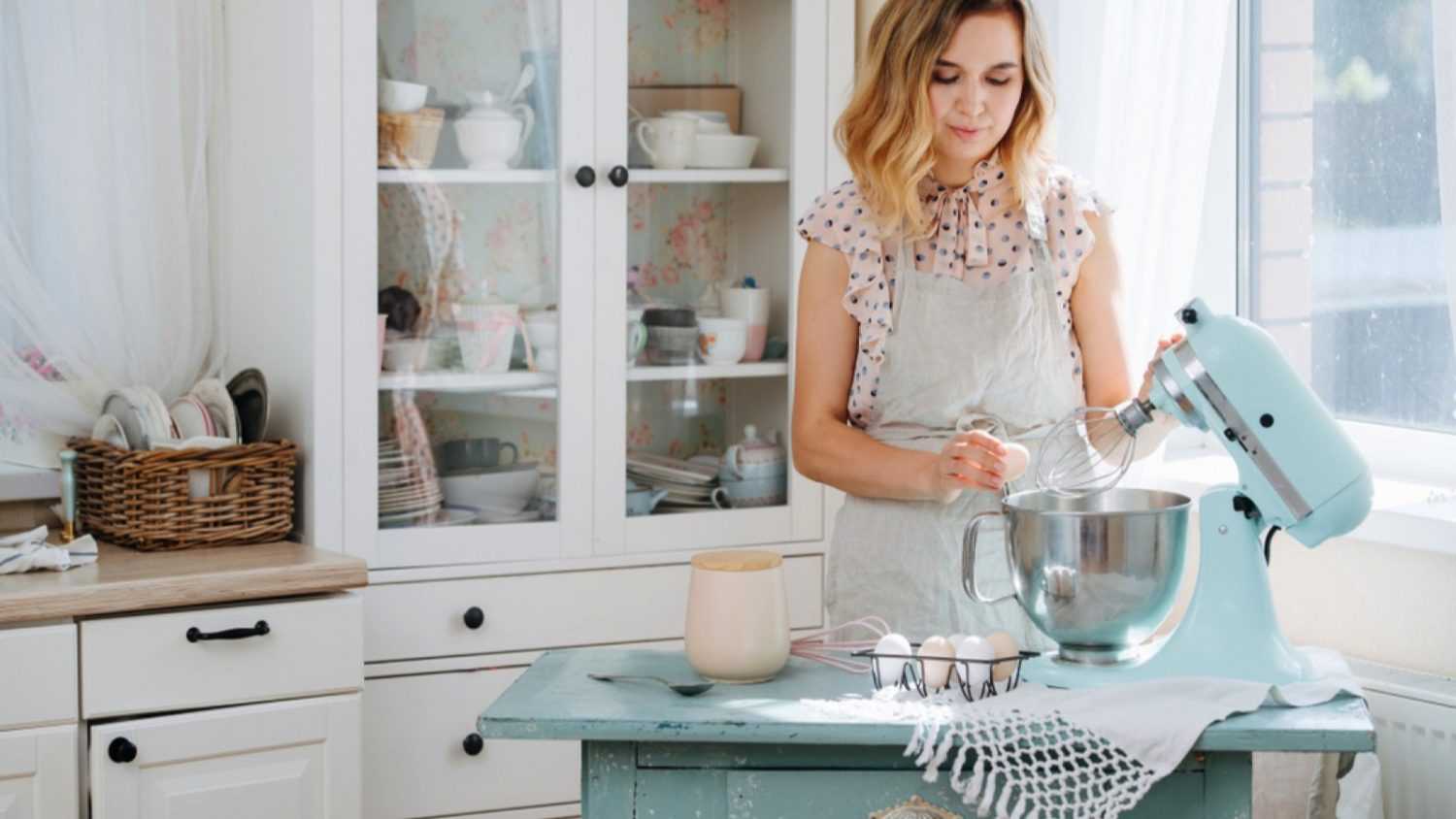 Woman using cake mixer