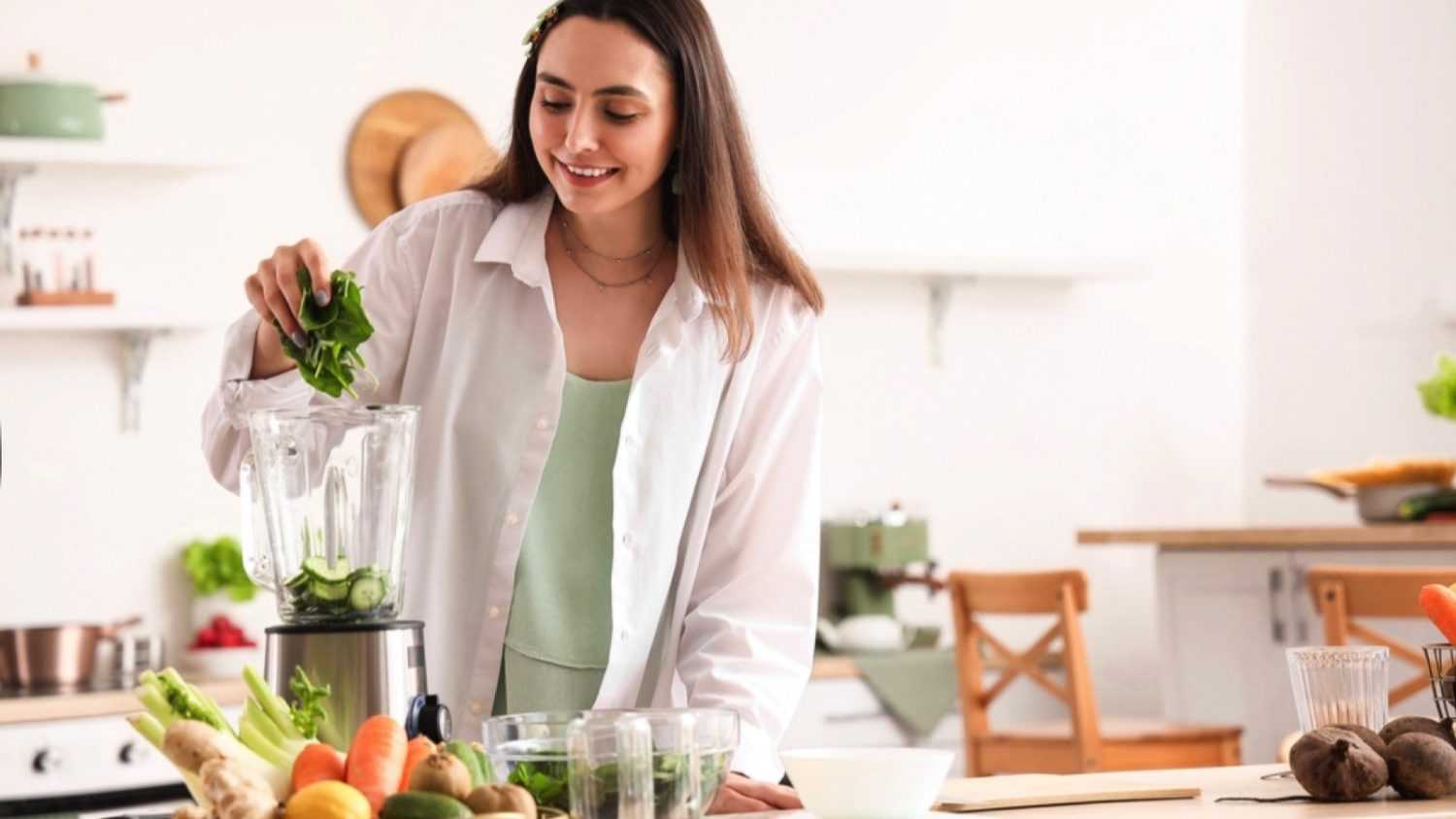 Woman blending spinach