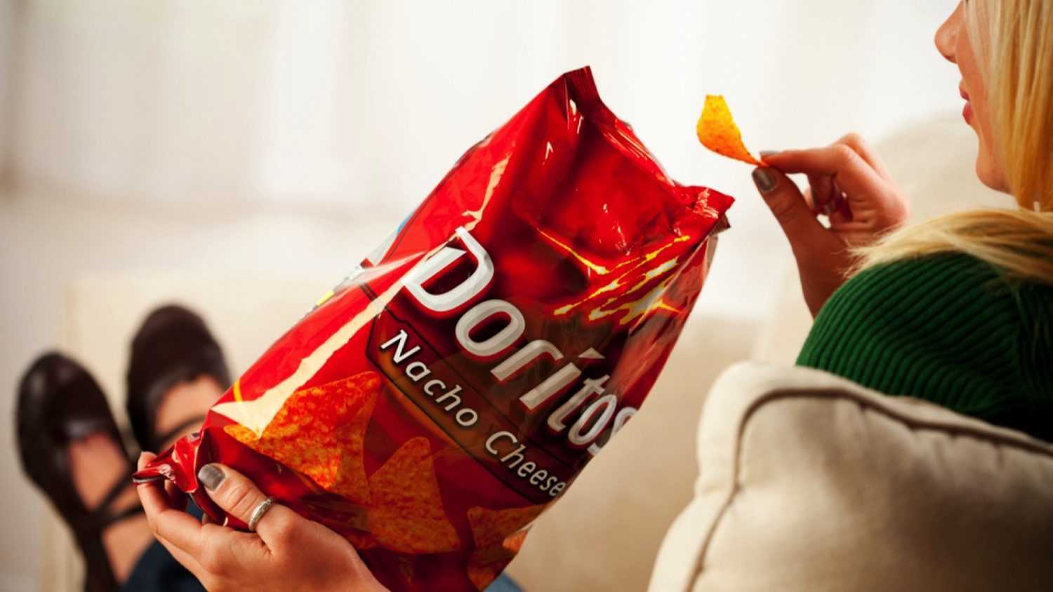 Woman eating Doritos