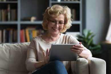 Happy old woman using ipad