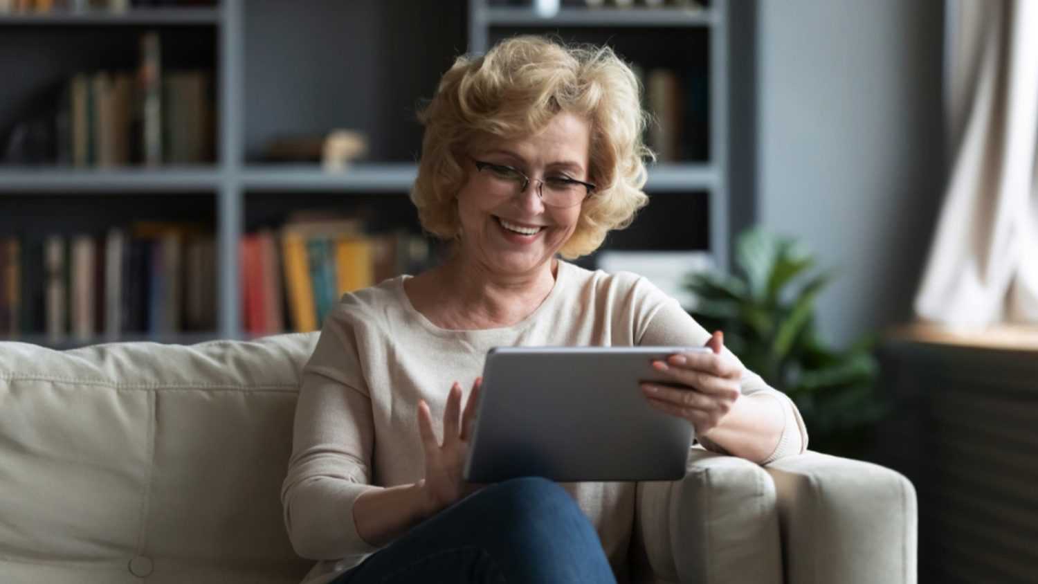 Happy old woman using ipad